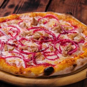 pizza with tuna and red onion on wooden cutting board
